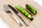 Green cucumbers on chopping board