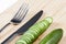 Green cucumbers on chopping board
