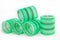 Green curlers on white background