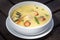Green curry creamy soup with coconut milk, shrimp, red pepper, bean in white bowl, Thai cuisine
