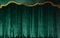 Green curtain of luxurious velvet on the theater stage. Copy space. The concept of music and theatrical art.