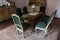 Green cushioned saloon antique nobility chairs, carved table, chest drawers, cupboards and other furniture from 19th century