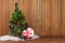 Green Decorated Christmas Tree and Gift on Wooden Background.