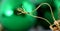 Green decorative christmas ball detail. gold colored hanging rope.macro shot in studio,