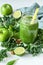 Green detox smoothie or blended juice in glass bottle on white