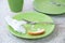 Green dirty plates with leftovers. On the stone kitchen countertop.