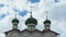 Green domes with Orthodox crosses of the monastery