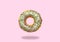 Green donut on on pastel pink background