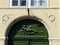 Green door with an engraved sculpture of a winged goddess to Budapest in Hungary.