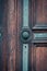 Green door knob handle on historic oak door with keyhole and ornate details
