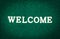 Green doormat and welcome text
