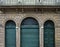 Green doors with grid on ancient facade