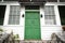 Green double door front entrance at top of stairs/ staircase at a vintage house/home