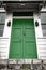 Green double door front entrance at top of stairs/ staircase at a vintage house/home