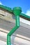 Green drainpipe roof drain pipe on vintage white wall, environment diversity,