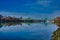 Green drawbridge across river in delta with reflections in the water