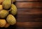 Green durian on the wooden board, Thai fruit. Space for text. Generative AI