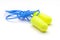 Green earplug noise protection for occupational safety on a white background.