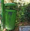 Green eco recyclable compost dispenser at the park trash organic bin bright green color