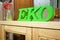 Green eco text symbol on wooden chest of drawers, close-up
