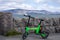 Green electric bike on Reykjavik waterfront. A luxury yacht anchored in the bay in the background, Iceland.