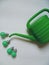 Green electric bulb and watering can for watering flowers on a white background