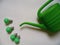 Green electric bulb and watering can for watering flowers on a white background