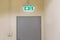 green emergency exit sign to install over the door building construction showing the way to escape