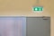 green emergency exit sign to install over the door building construction showing the way to escape