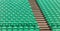 Green empty stadium folding seats and wooden stairs