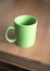 Green empty tea or coffee cups on wooden table clos-up