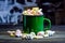 Green enameled mug with marshmallows