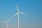 Green energy.Wind generator on blue sky background.Natural energy.Windmill on sky background. renewable energy.