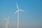 Green energy.Wind generator on blue sky background.Windmill on sky background. renewable energy.Environmentally friendly