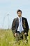 Green energy - Young businessman in field windmill