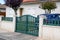 Green entrance portal design on home metal aluminum gate front of suburb door house