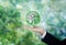 Green and environmental global business. Businessman hand holding globe with green Bokeh background. Element of this image are fur