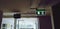 Green exit sign with light on hanging on ceiling when emergency of fire case and help person to know the way to go out building.