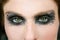 Green eyes woman, black makeup eye shadow