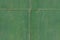 Green faded metal wall with cross from metal stripes on the middle