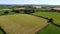 Green farm fields separated by shrubs, top view. Cattle pastures in the south of Ireland. Agricultural landscape, nature