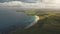 Green farmland at sun ocean bay aerial. Nobody nature landscape. Yellow fields, meadows at summer