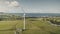 Green farmland wind turbine aerial. Nobody nature sun landscape. Power plant with solar panels