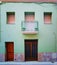 Green faÃ§ade and Balcony with two vases in Figueres