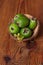 Green feijoa in a coconut shell hulf on a wooden background. Ripe tropical fruits, raw vegan food.Vitamin C. Copy space