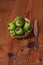 Green feijoa in a coconut shell hulf on a wooden background. Ripe tropical fruits, raw vegan food.Vitamin C. Copy space