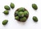 Green feijoa fruits in a cork plate isolated on a white background. Tropical fruit feijoa. Set of ripe feijoa fruits. the view