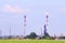 Green field and big Oil Refinery with pipes