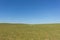 Green field , clear blue sky , rural landscape background