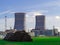 Green field and haystacks on the background of Nuclear power plant. Belarusian Nuclear power plant